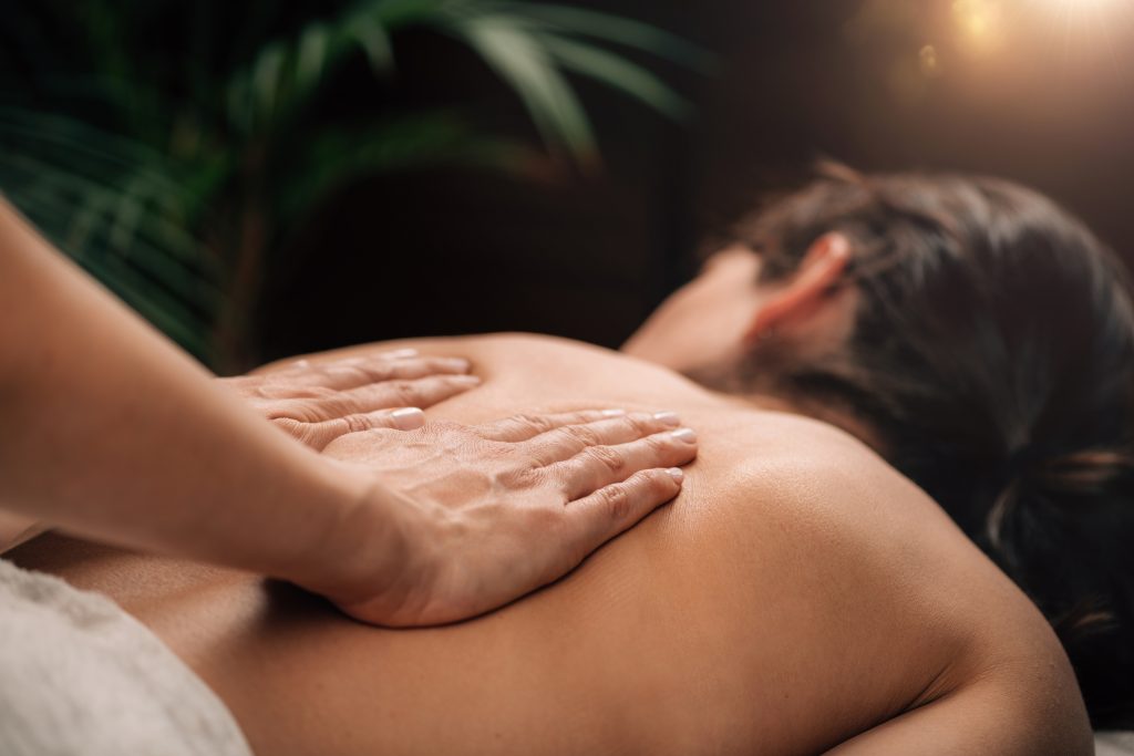 Deep Tissue Massage Therapy. Therapist massaging Woman’s Back